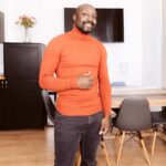 black porn actor Sid Jackson in orange sweater