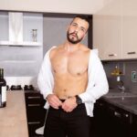 bearded gay stud with shirt unbuttoned showing his abs and chest