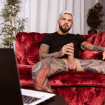 Clothed gay male strokes his cock in VR cam show.