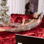 Juan Lucho reclines naked on his sofa, stroking his big stiff cock.